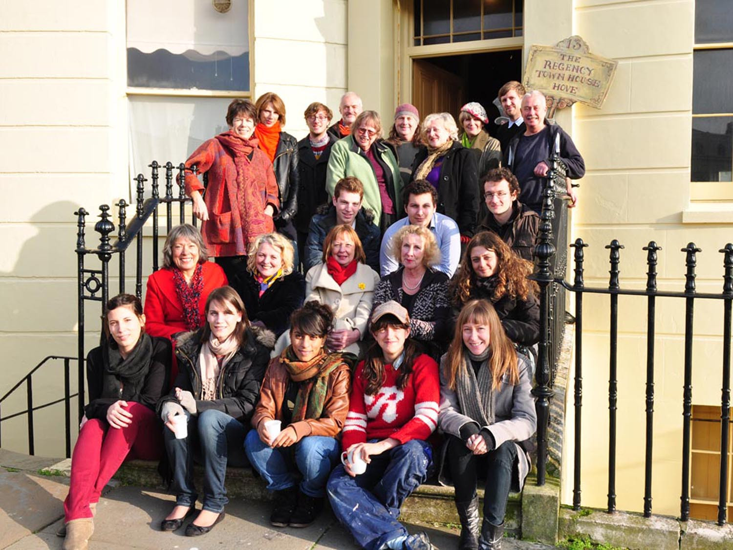 Photo showing 24 volunteers arranged on the steps of the Town House