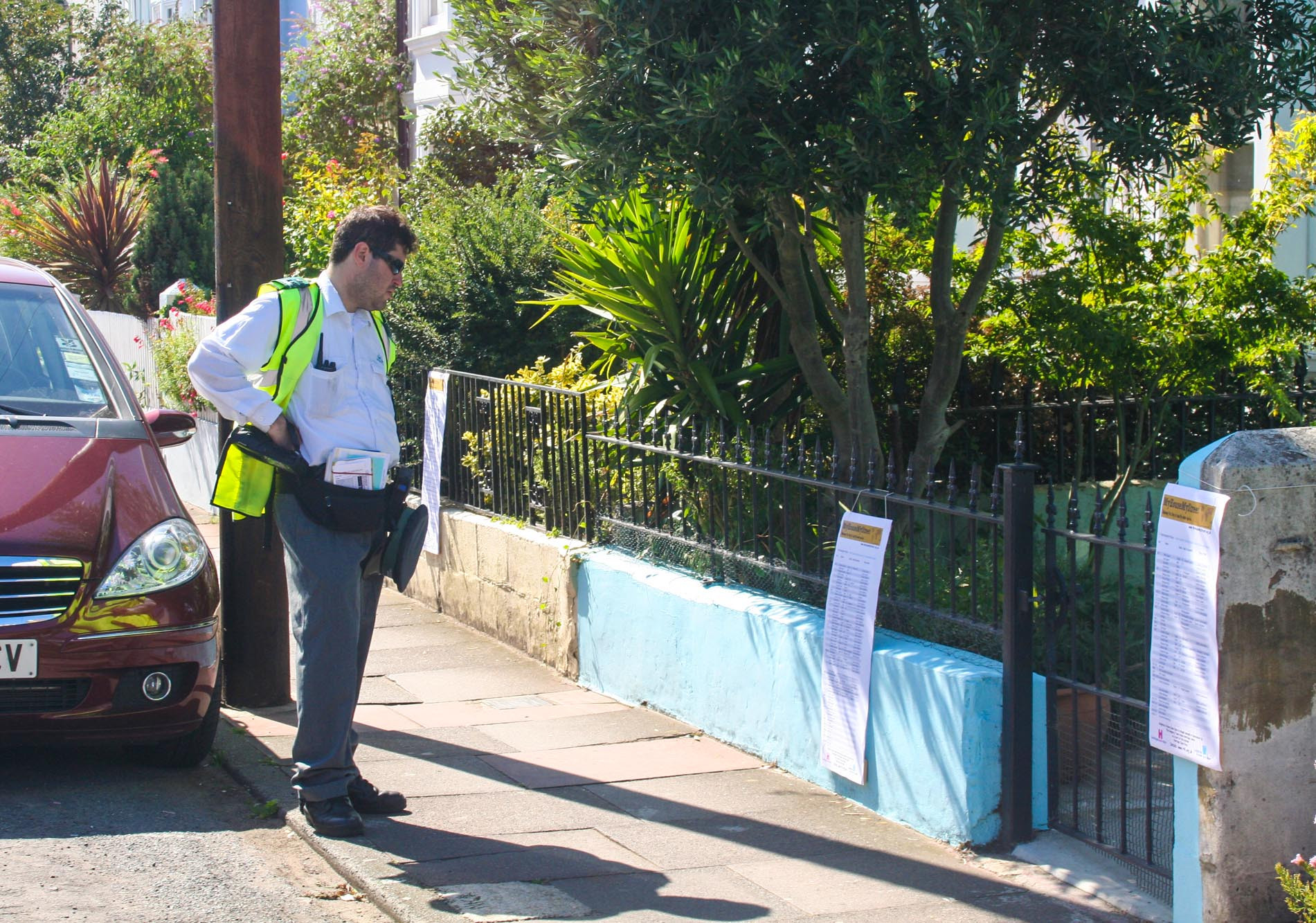 Traffic warden viewing street exhibition posters